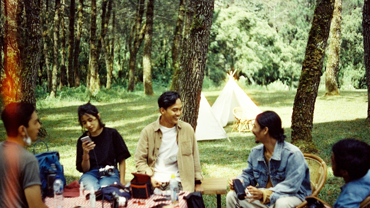 a group of people sitting around a picnic table