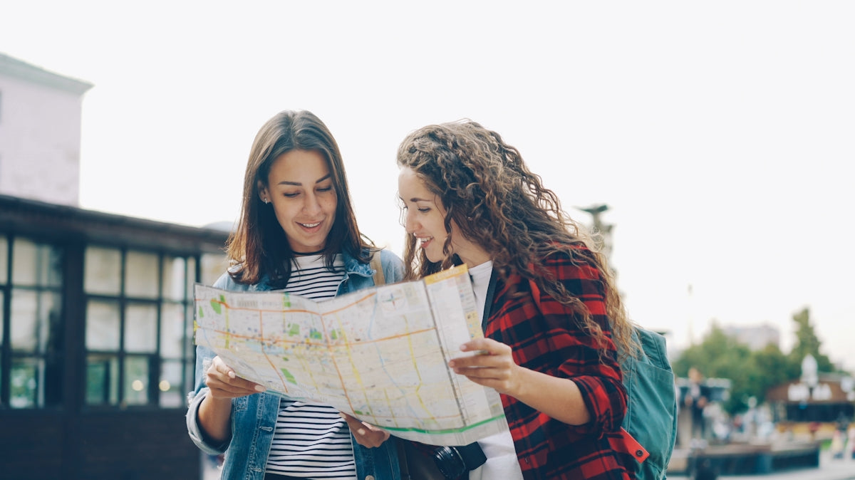 Two women are looking at a map together.