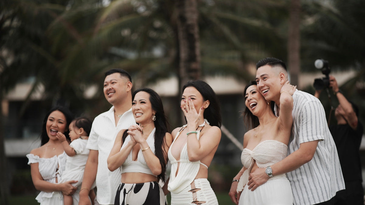 A group of people dressed in white on a beach