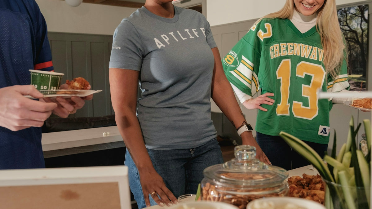 People gathered around a buffet table with food.