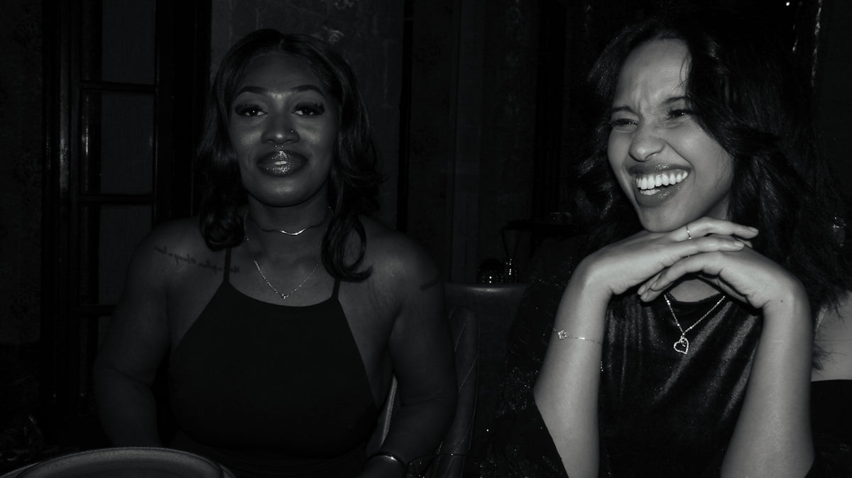 Two women laughing together at a table.